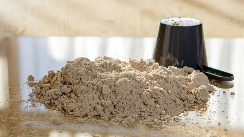 Whey protein powder with a measuring scoop